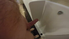 Peeing naked at a public urinal Thumb